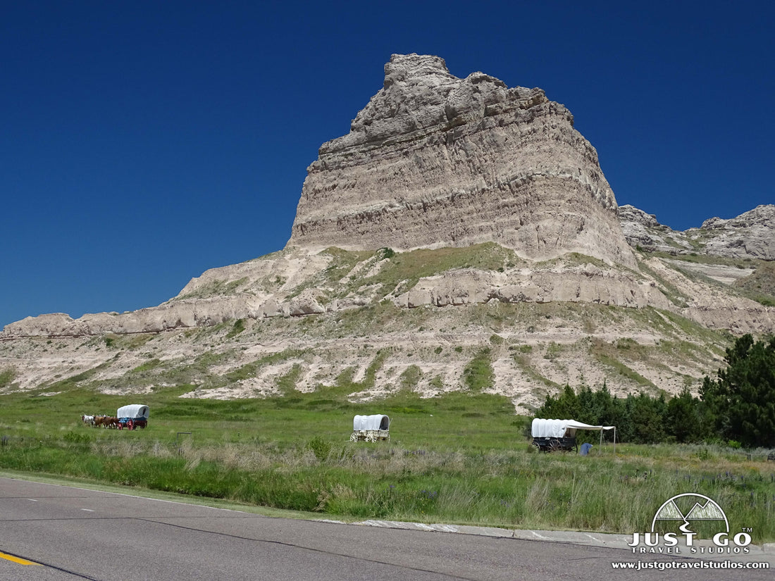 Covered wagons in front of Scotts Bluff