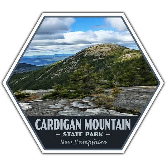 A hexagonal sticker or patch design featuring a scenic landscape of Cardigan Mountain in New Hampshire, with a rocky peak, green forest, blue sky, and the text 'CARDIGAN MOUNTAIN - STATE PARK - New Hampshire' on a dark background.