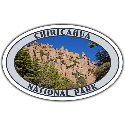 An oval sticker or decal featuring a landscape photo of Chiricahua National Park with tan rock formations and green trees under a blue sky, bordered by a white ring with the words 'CHIRICAHUA NATIONAL PARK' in dark lettering.