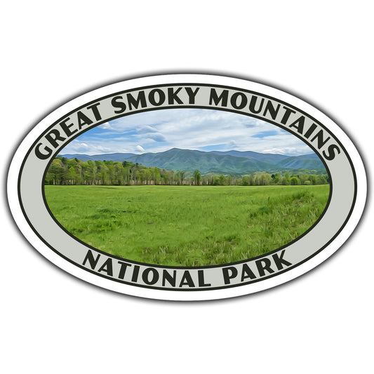 Oval sticker with 'Great Smoky Mountains National Park' text and scenic view of a field and mountains.